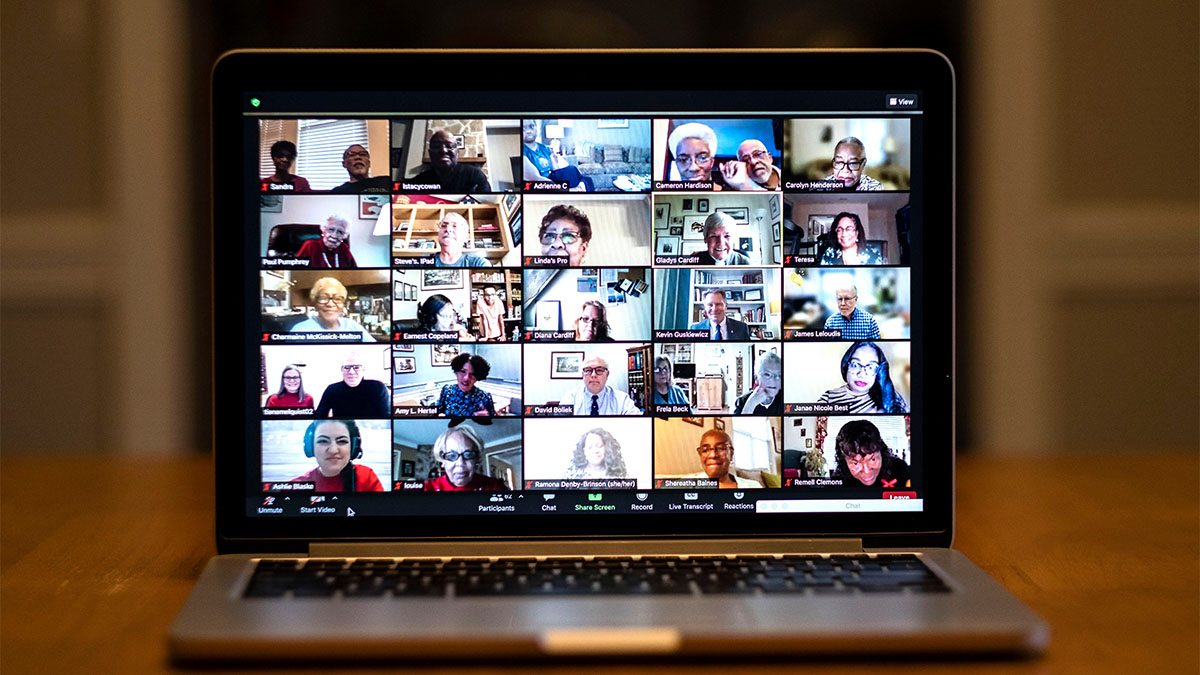Photo of a laptop screen displaying a Zoom call with many participants.