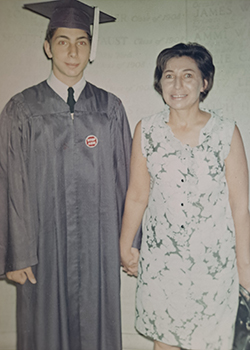 David Weber holds hands with his mother Evelyn at his high school graudation.