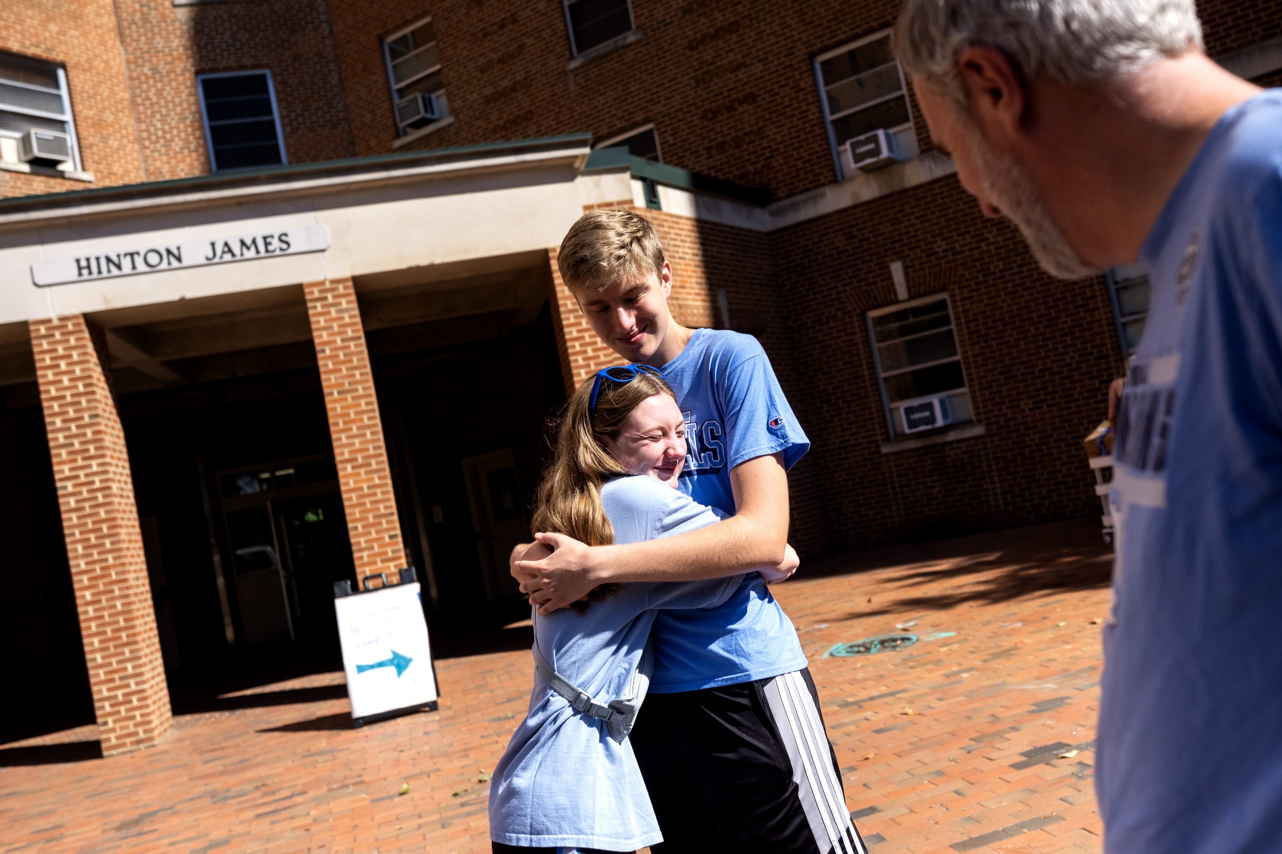 An incoming first-year college student hugging his sister outside of a residence hall on the campus of UNC-Chapel Hill.