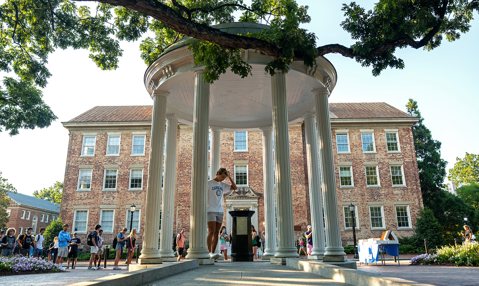 A student approaches the fountain of the Old Well on the campus of UNC-Chapel Hill