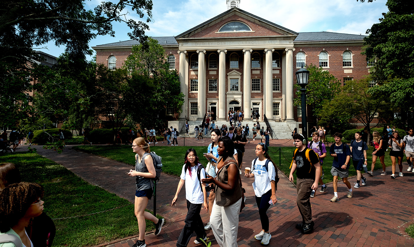 A crowd of students walking on the campus of UNC-Chapel Hill.