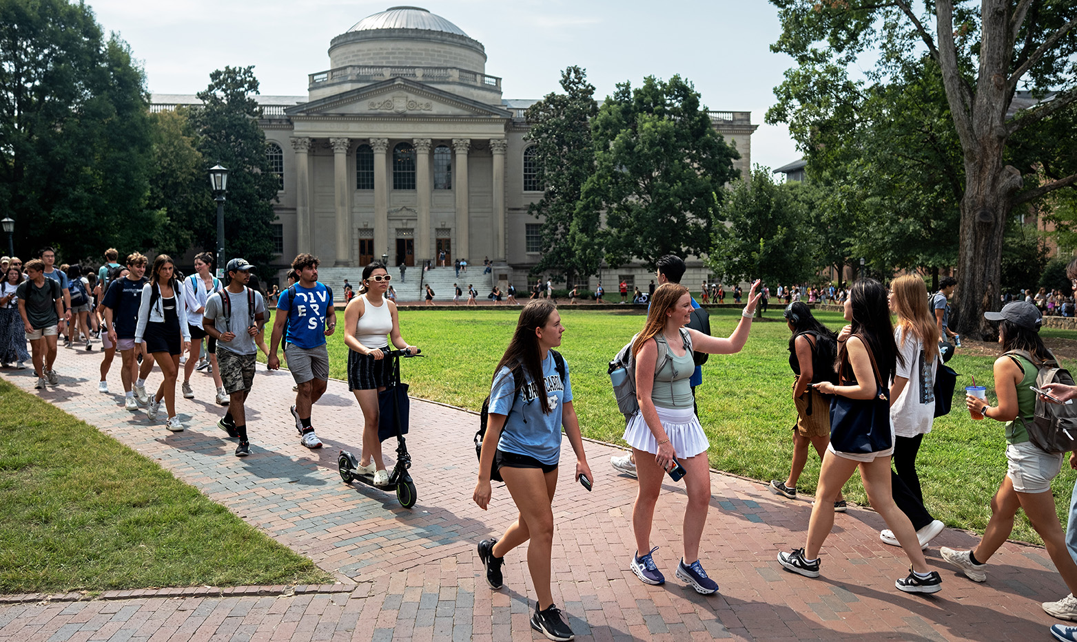 A crowd of students walking on Polk Place on the campus of UNC-Chapel Hill.