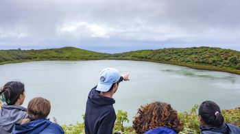 Five people looking at a lake in the Galapagos Islands.