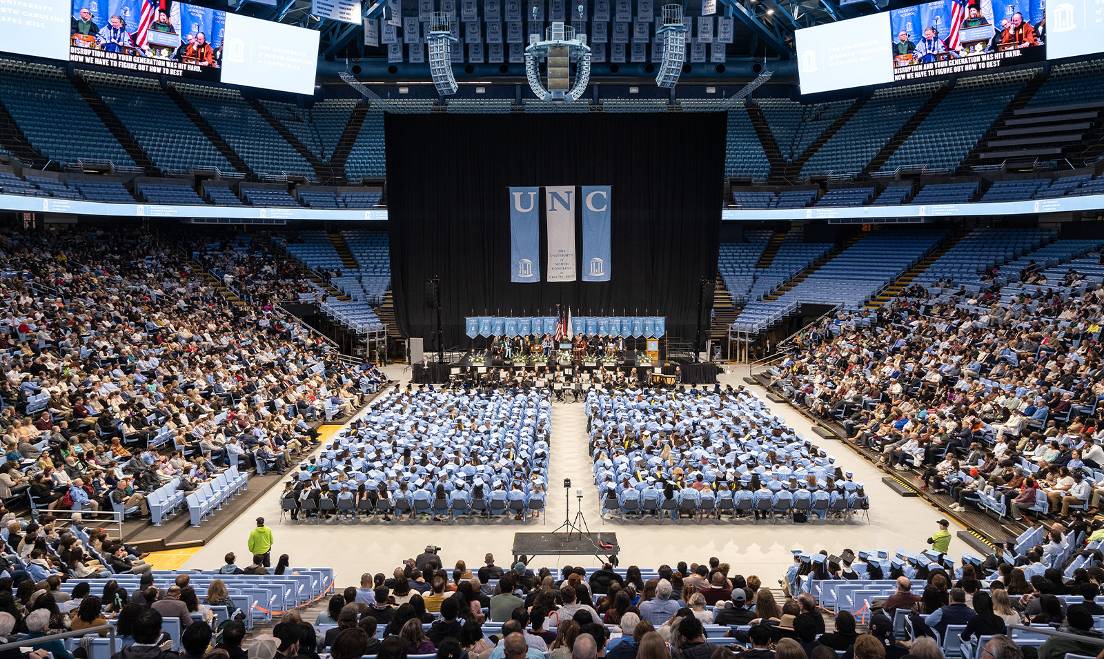 Far-distanced crowd shot of graduates and attendees at Winter Commencement in the Dean E. Smith Center.
