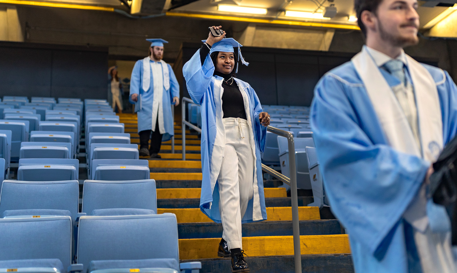 Graduates walking down steps at Winter Commencement at the Dean E. Smith Center.