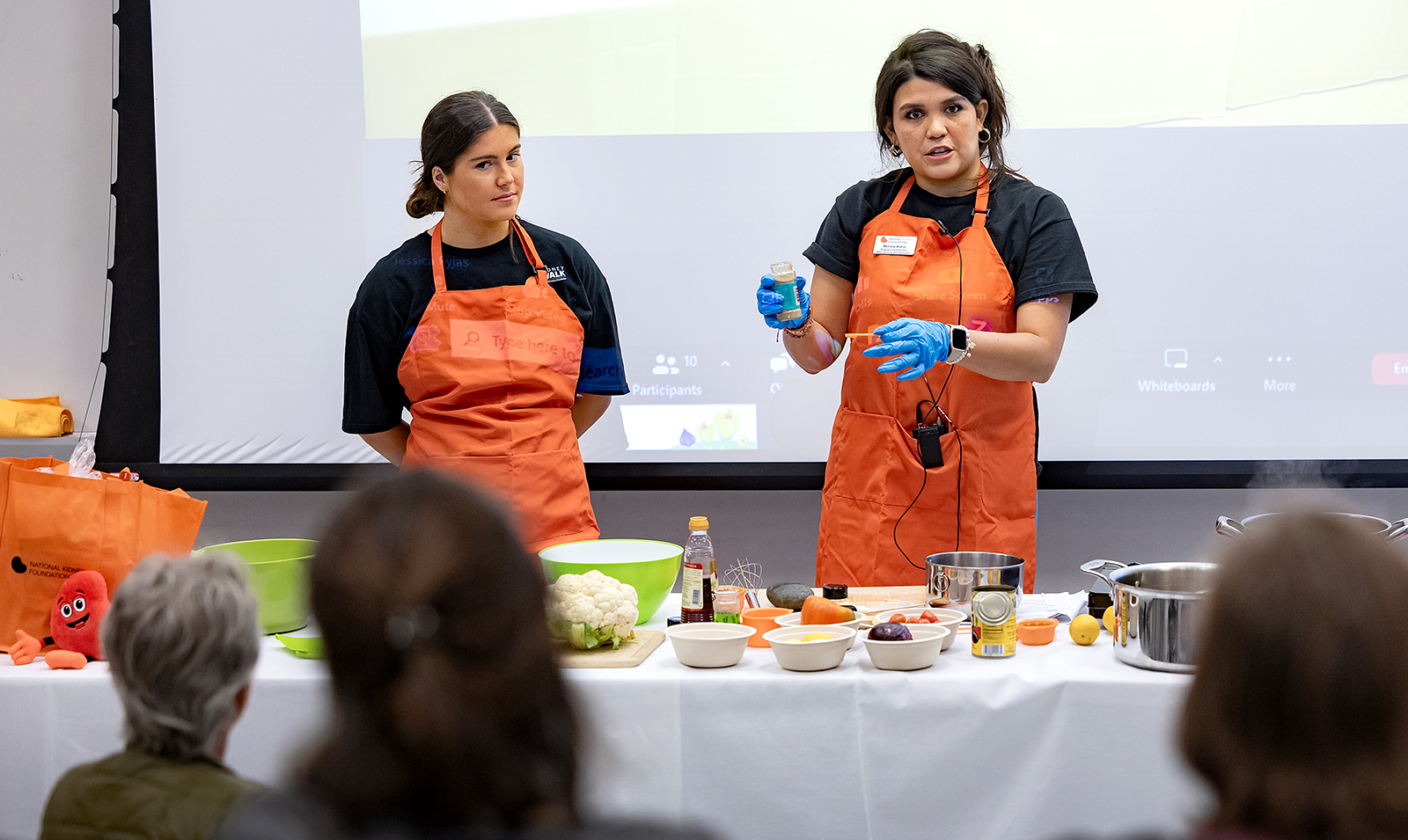 Two people performing a cooking demonstration