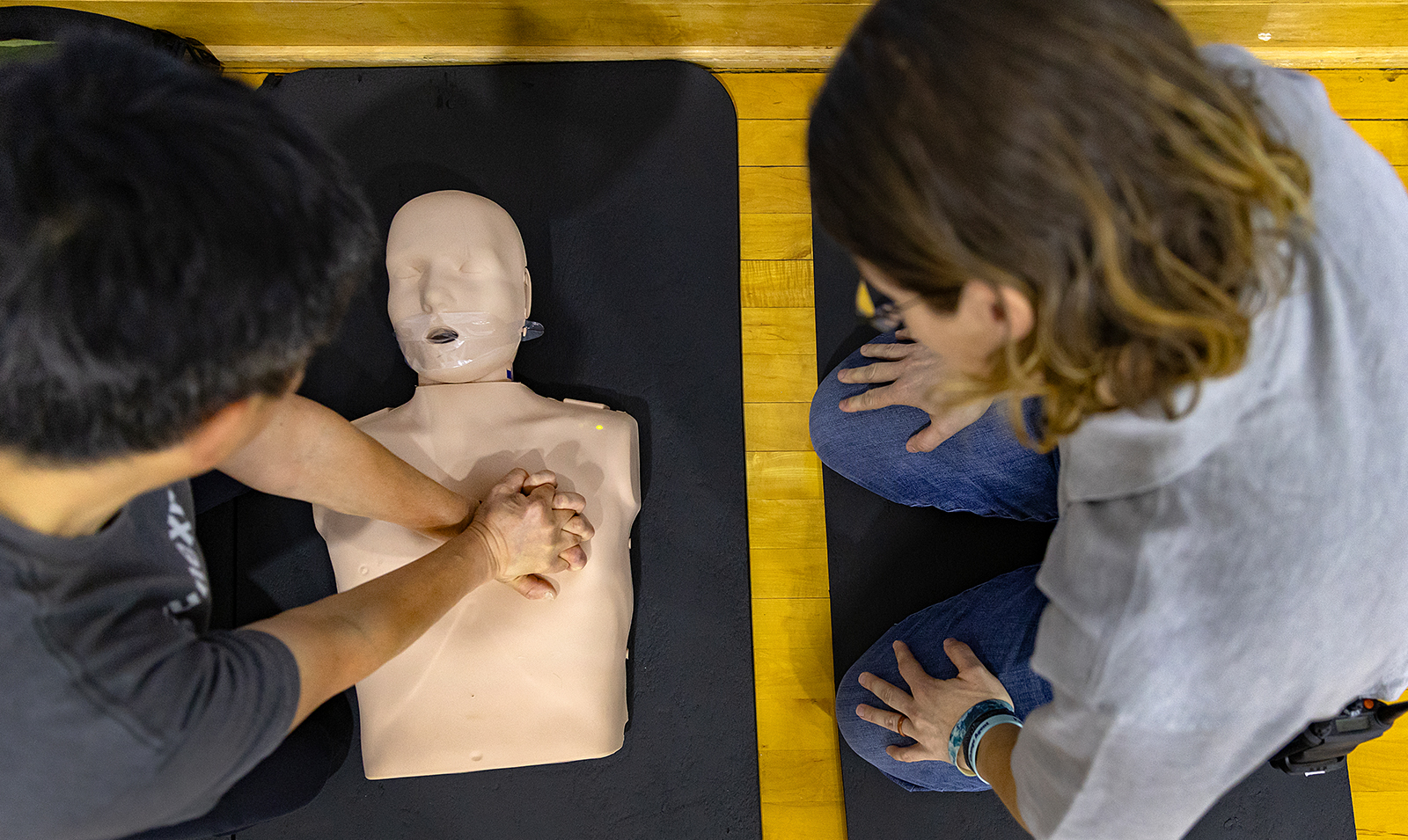 Person performing CPR on mannequin