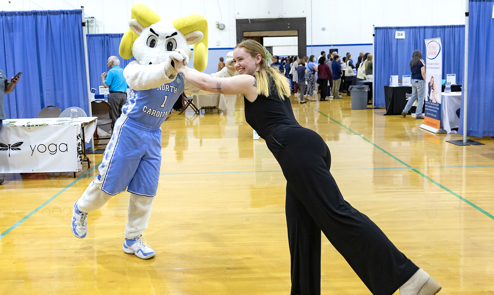 Woman dancing with Rameses the mascot