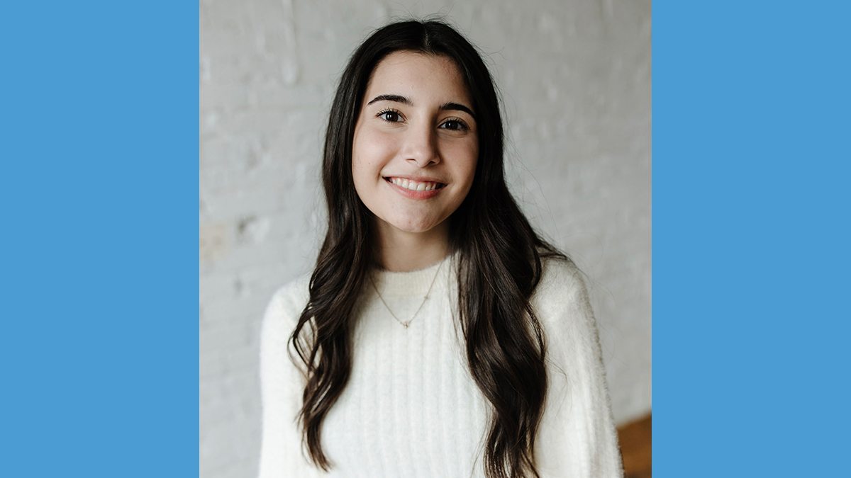 Headshot of Tehya Sepulvado in front of white wall with Carolina blue border.