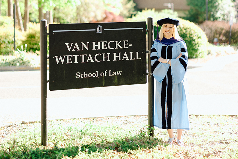 Meighan Parsh in front of School of Law sign