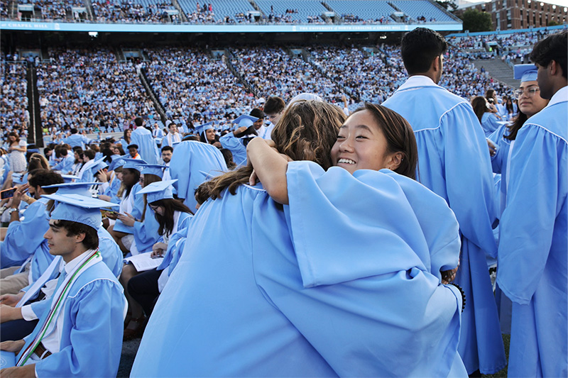 Two students hugging at Commencement.