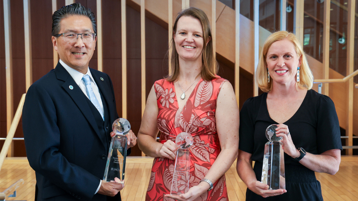 Koji Sode, Courtney Rivard and Erinn Whitaker all holding their Global Excellence trophies.