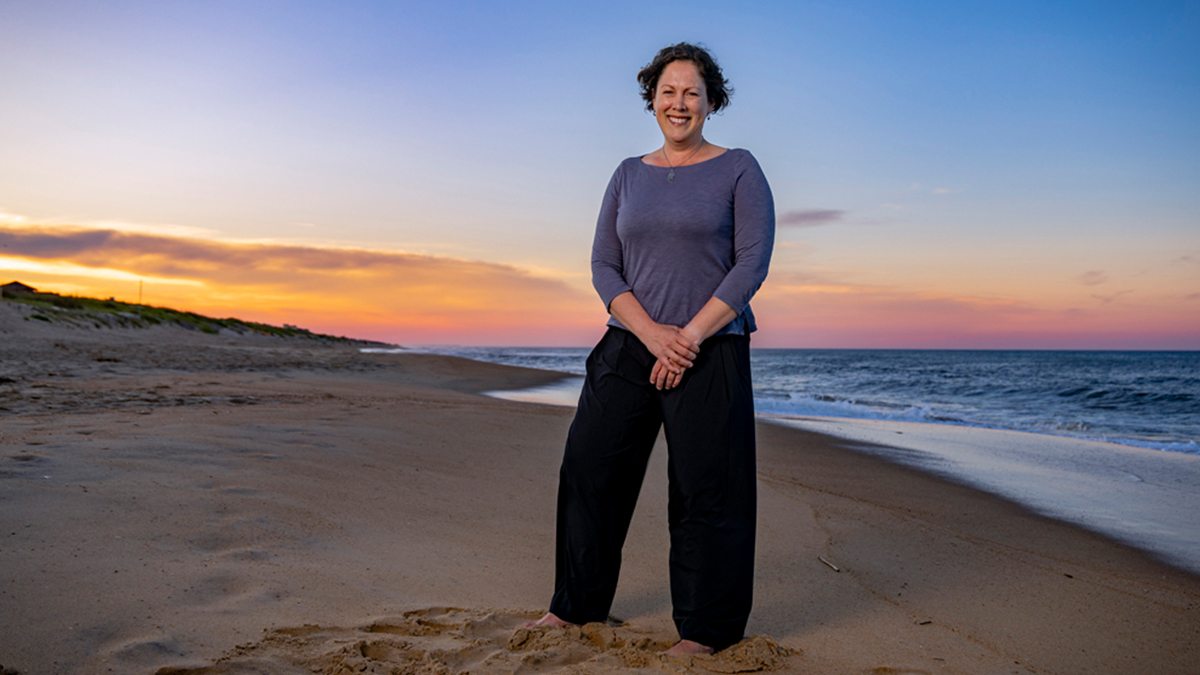 Megan Mendenhall posing on the beach at dusk.