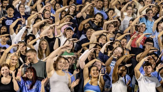 First-year students doing cheers at a pep rally event at Kenan Stadium.