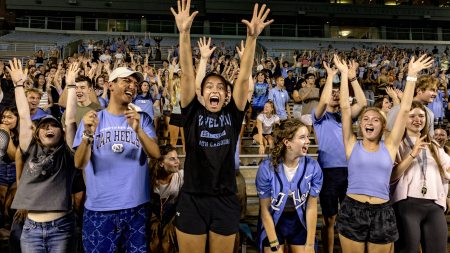 Students cheering and jumping at pep rally.