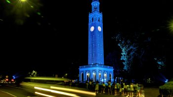 The Bell Tower lit up Carolina Blue at night.