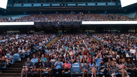 Students in stands at Dean E. Smith Center