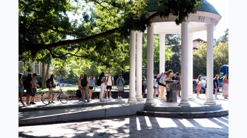 Student taking a drink from the Old Well.