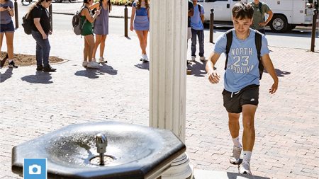 Student approaching the fountain of the Old Well for his First Sip on the first day of classes at UNC-Chapel Hill.