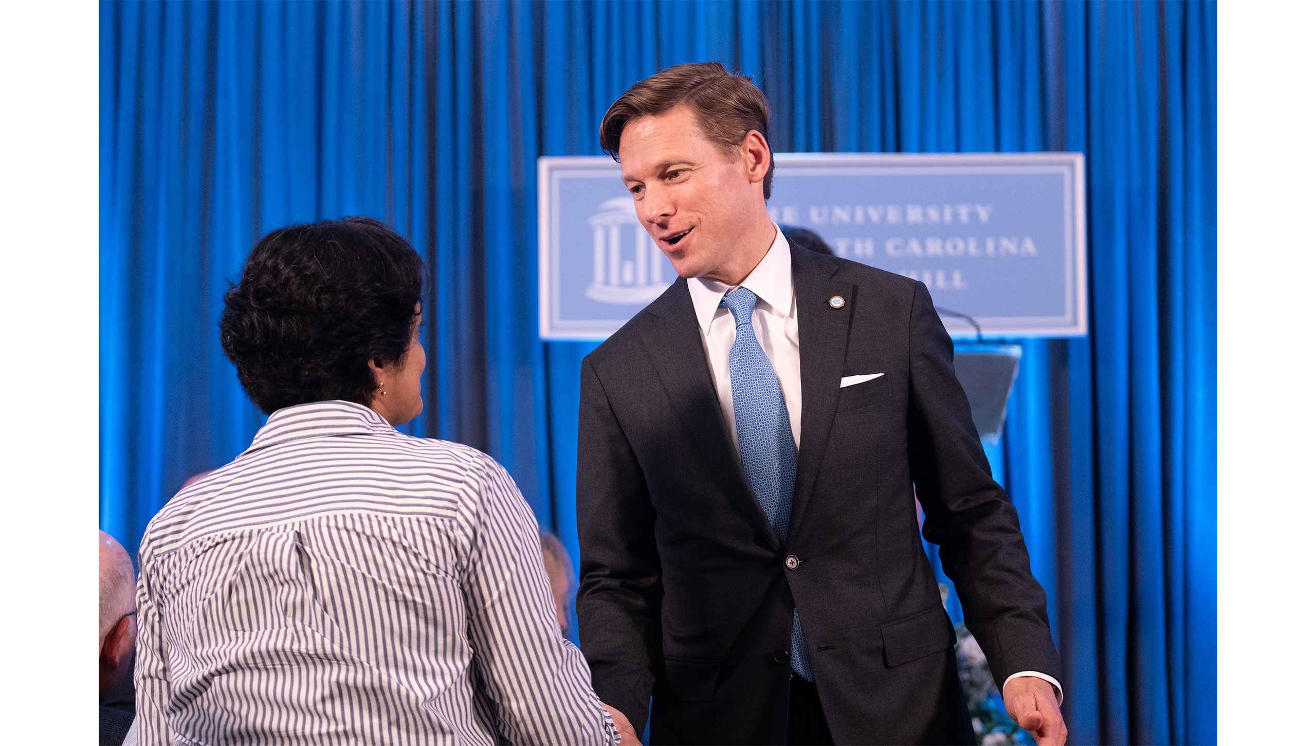 Lee Roberts shakes hands at campus event