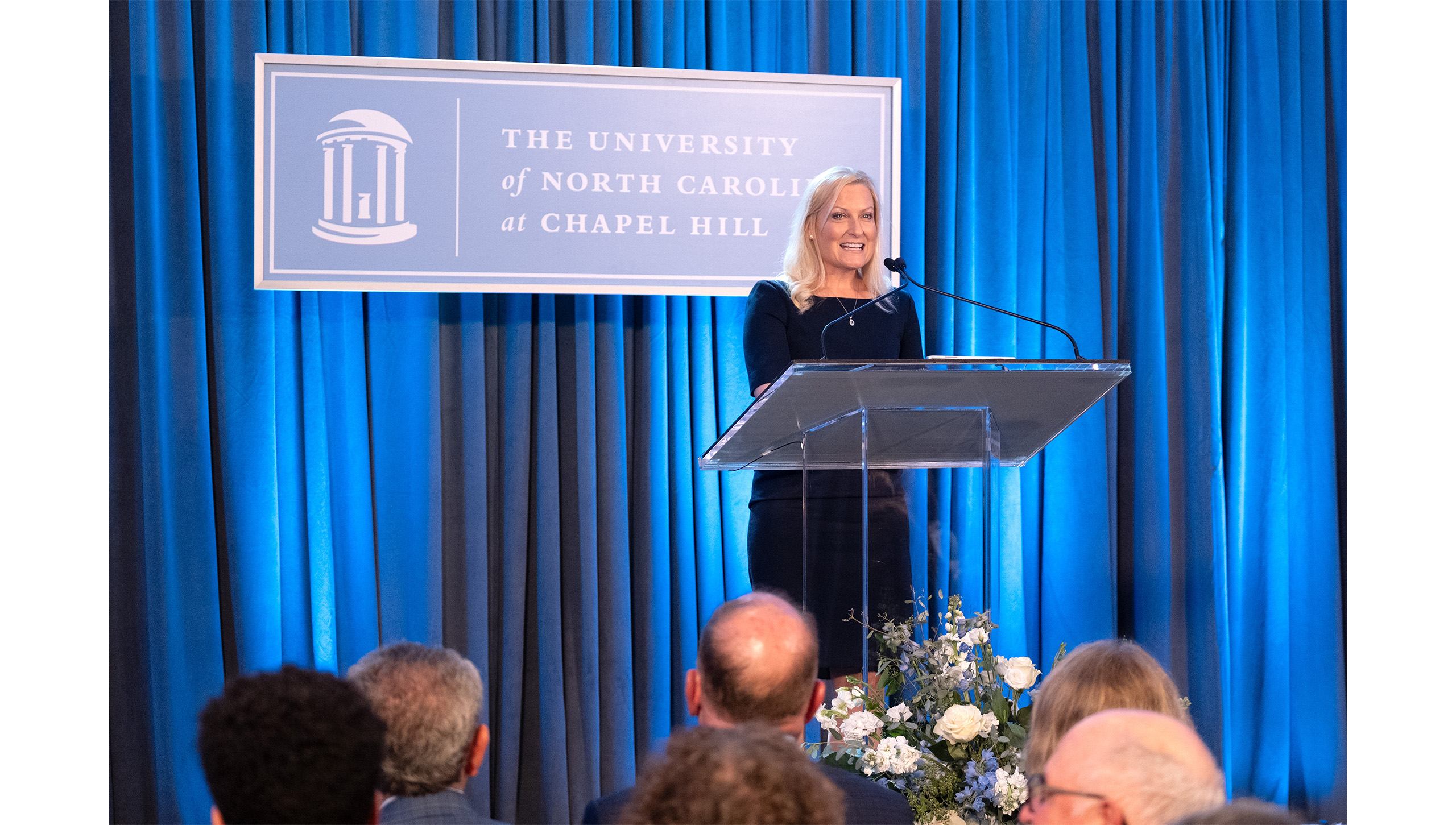 Cristy Page speaks on a podium