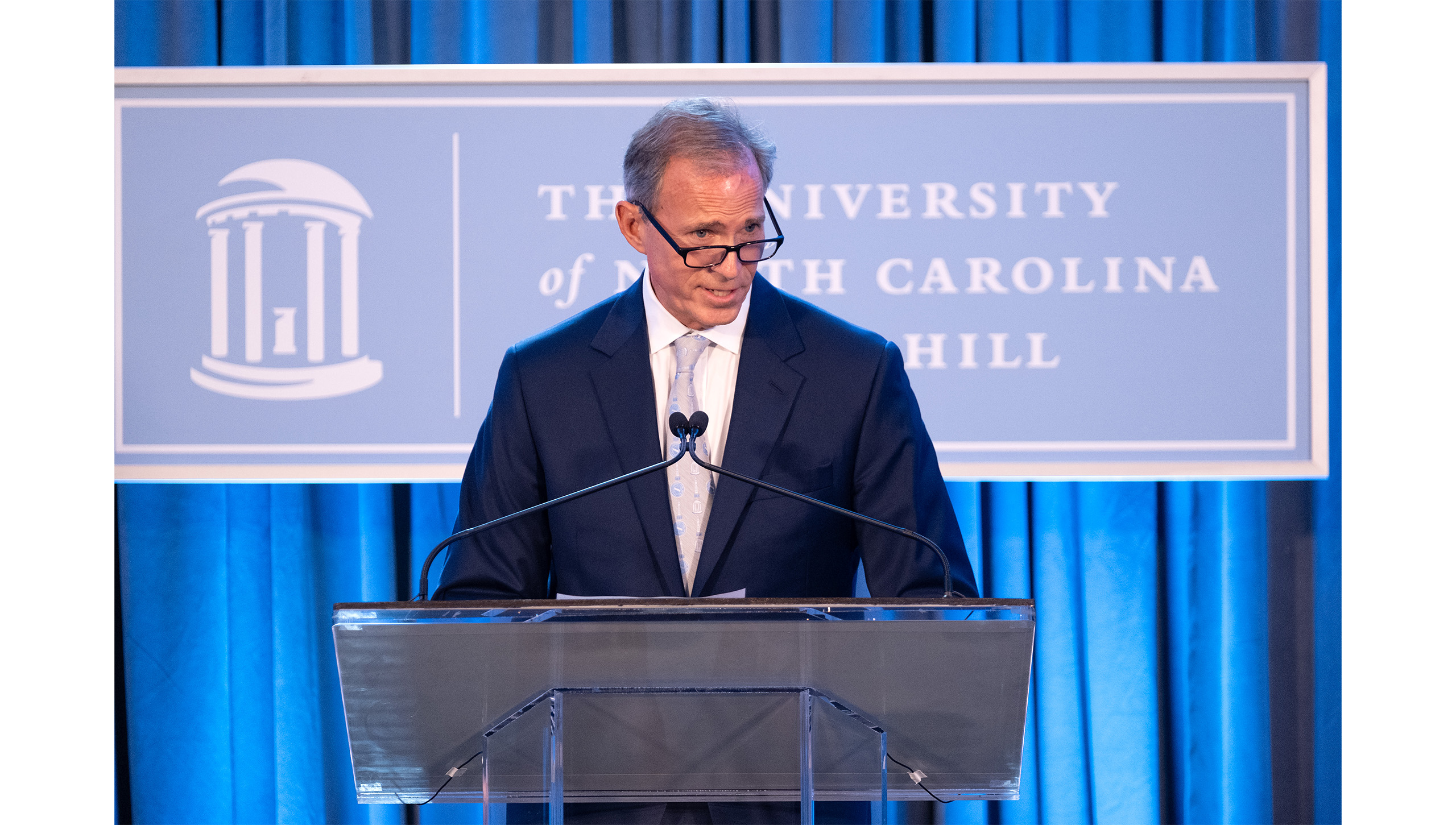 John Preyer speaks on a podium