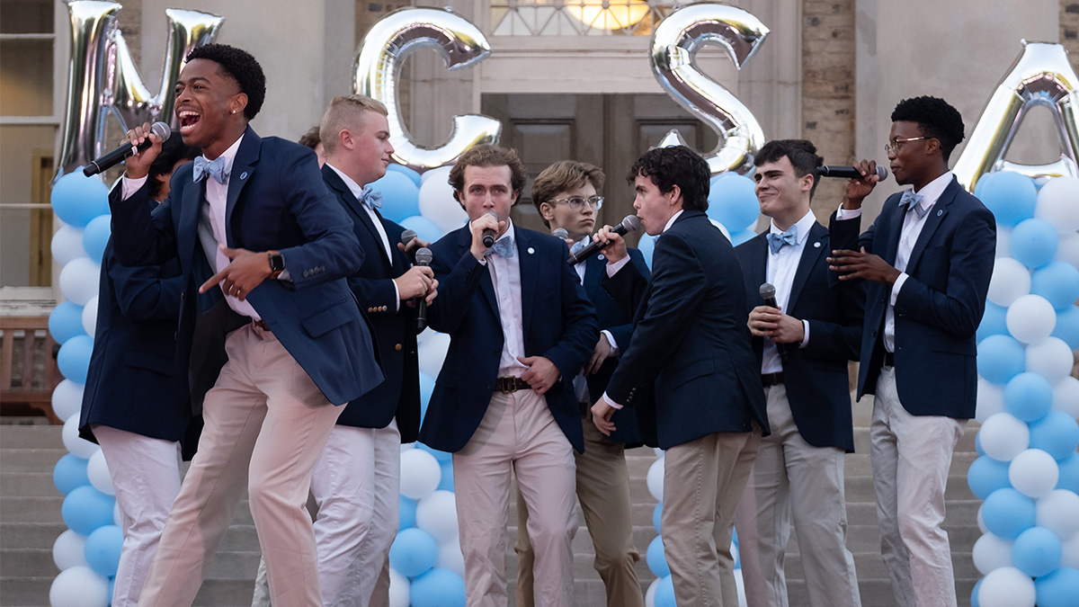 A cappella group performs in front of South Building