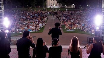 A student a cappella group performing in front of an audience on Polk Place on the campus of UNC-Chapel Hill at Sunset Serenade.