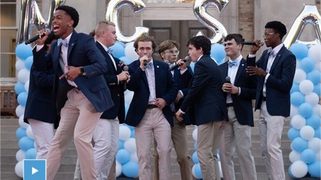 A student a cappella group performing at Sunset Serenade in front of South Building.