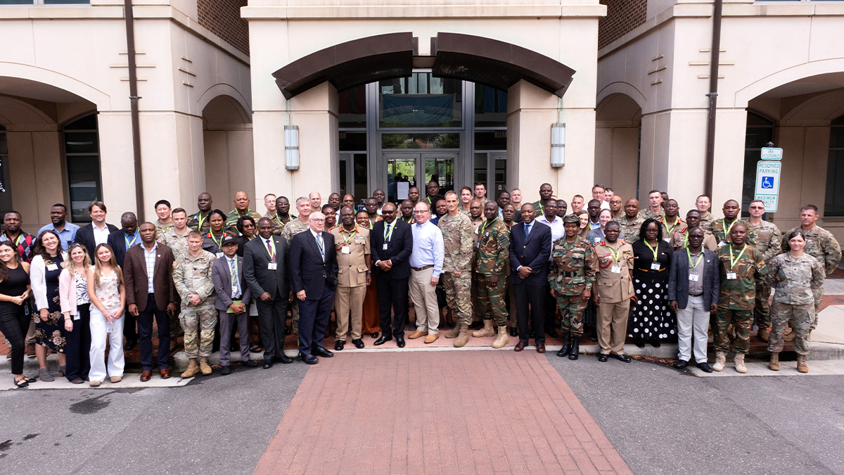 A group photo of UNC-Chapel Hill faculty and leaders along with dignitaries from Malawi, Zambia and Botswana in front of the Bioinformatics Building on the campus of UNC-Chapel Hill.