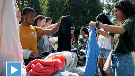 UNC Students looking through clothing.