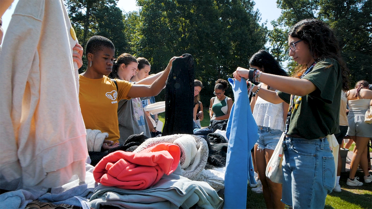 UNC Students looking through clothing.