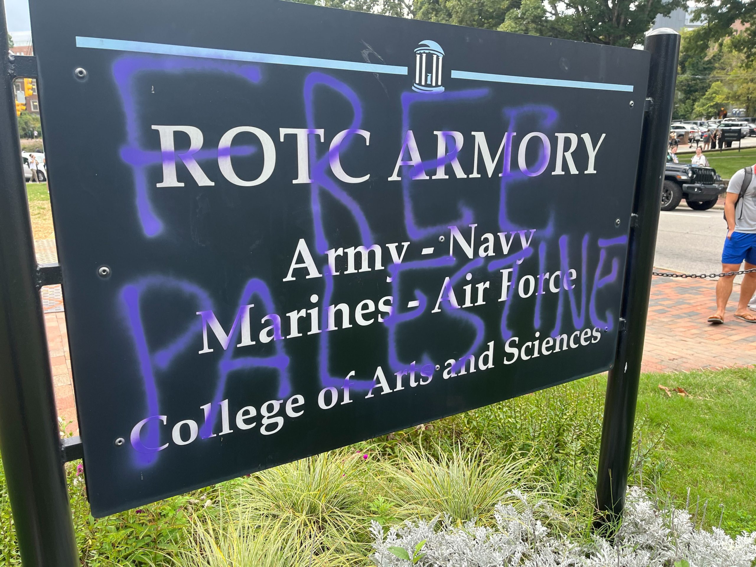 Sign for ROTC Armory with spray paint over the name, reading "FREE PALESTINE"