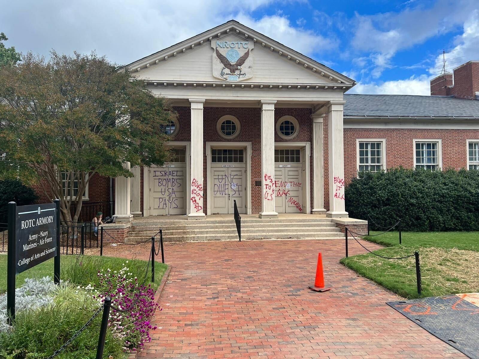 ROTC Armory building with spray paint on doors and pillars