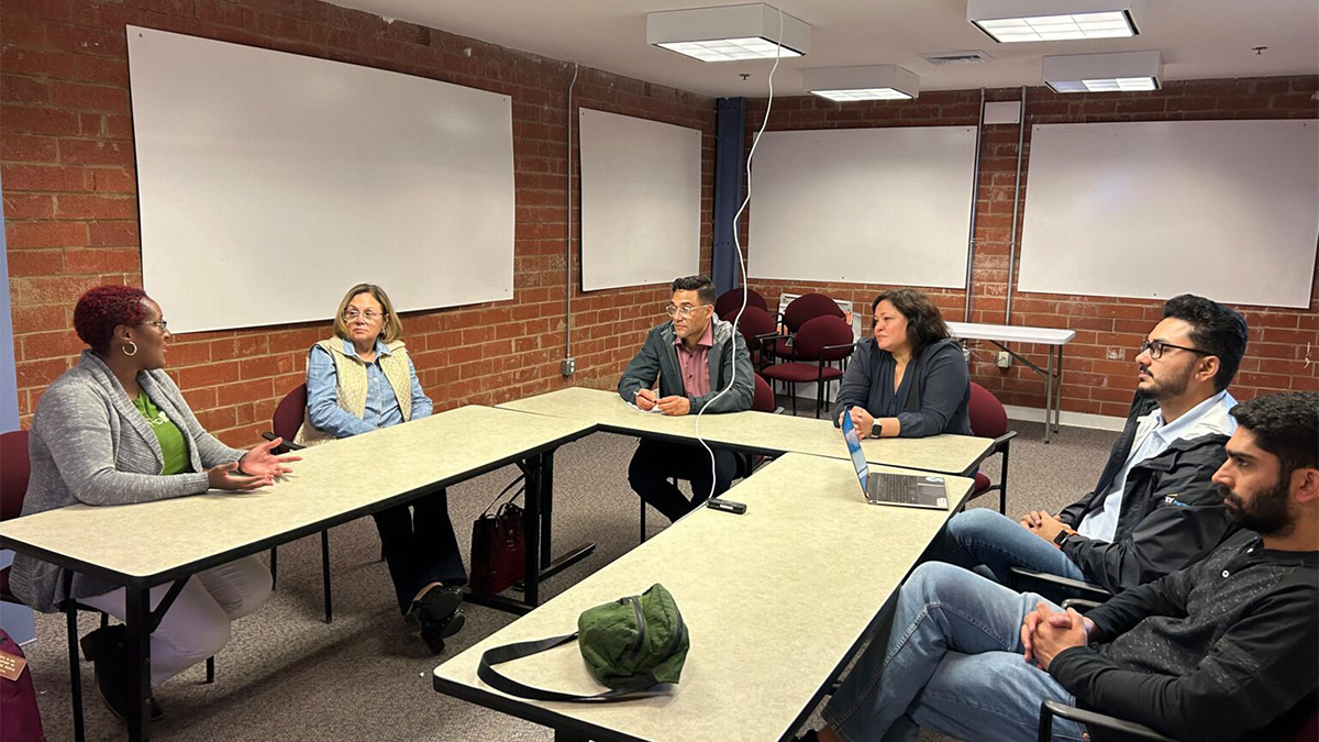 Counter-clockwise from the right: Hammad Nadeem (MBA ’24), Abdur Rahman (MBA ’24) and Senior Program Manager Christina Theodorou discuss the Liberty co-packing facility project with stakeholders.