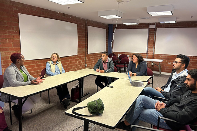 Counter-clockwise from the right: Hammad Nadeem (MBA ’24), Abdur Rahman (MBA ’24) and Senior Program Manager Christina Theodorou discuss the Liberty co-packing facility project with stakeholders.