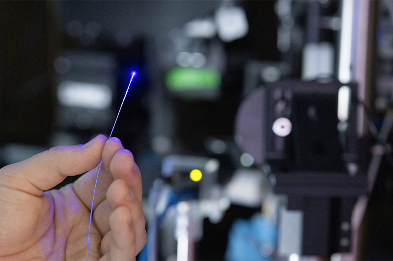 A closeup of a hand holding a beam of light.