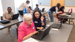 A UNC-Chapel Hill student instructor, Rebecca Topper, giving one-on-one help to a library patron, Jan Touma, during a workshop on digital literacy.