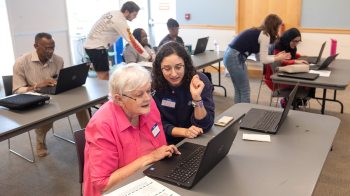 A UNC-Chapel Hill student instructor, Rebecca Topper, giving one-on-one help to a library patron, Jan Touma, during a workshop on digital literacy.