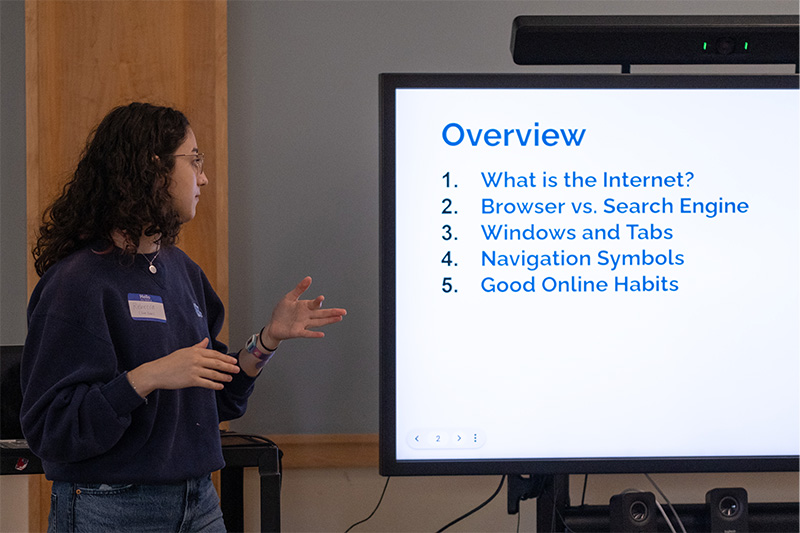 A UNC-Chapel Hill student instructor, Rebecca Topper, giving a presentation on digital literacy in a classroom at a local library.