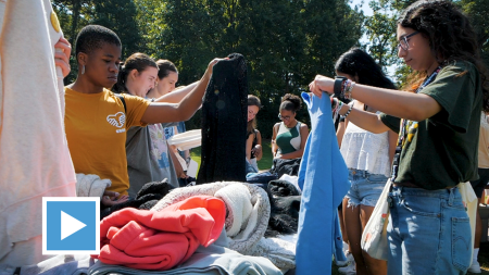 UNC Students looking through clothing.