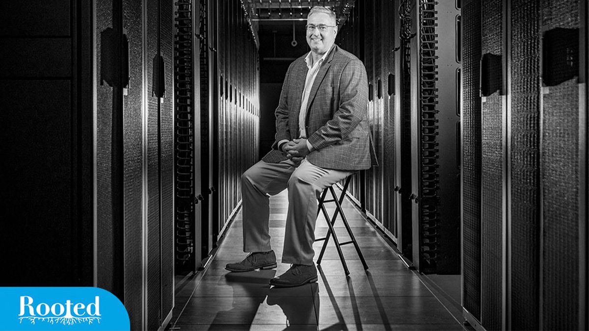 Black-and-white portrait of Jonathan Crabtree seated in a computer server room.