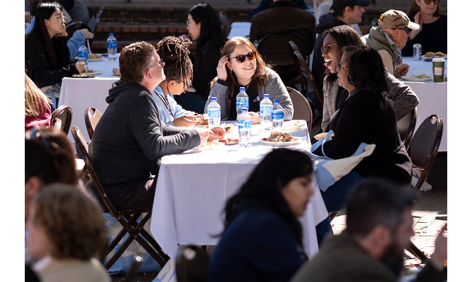 Carolina employees chat at a table with food during Employee Appreciation Day