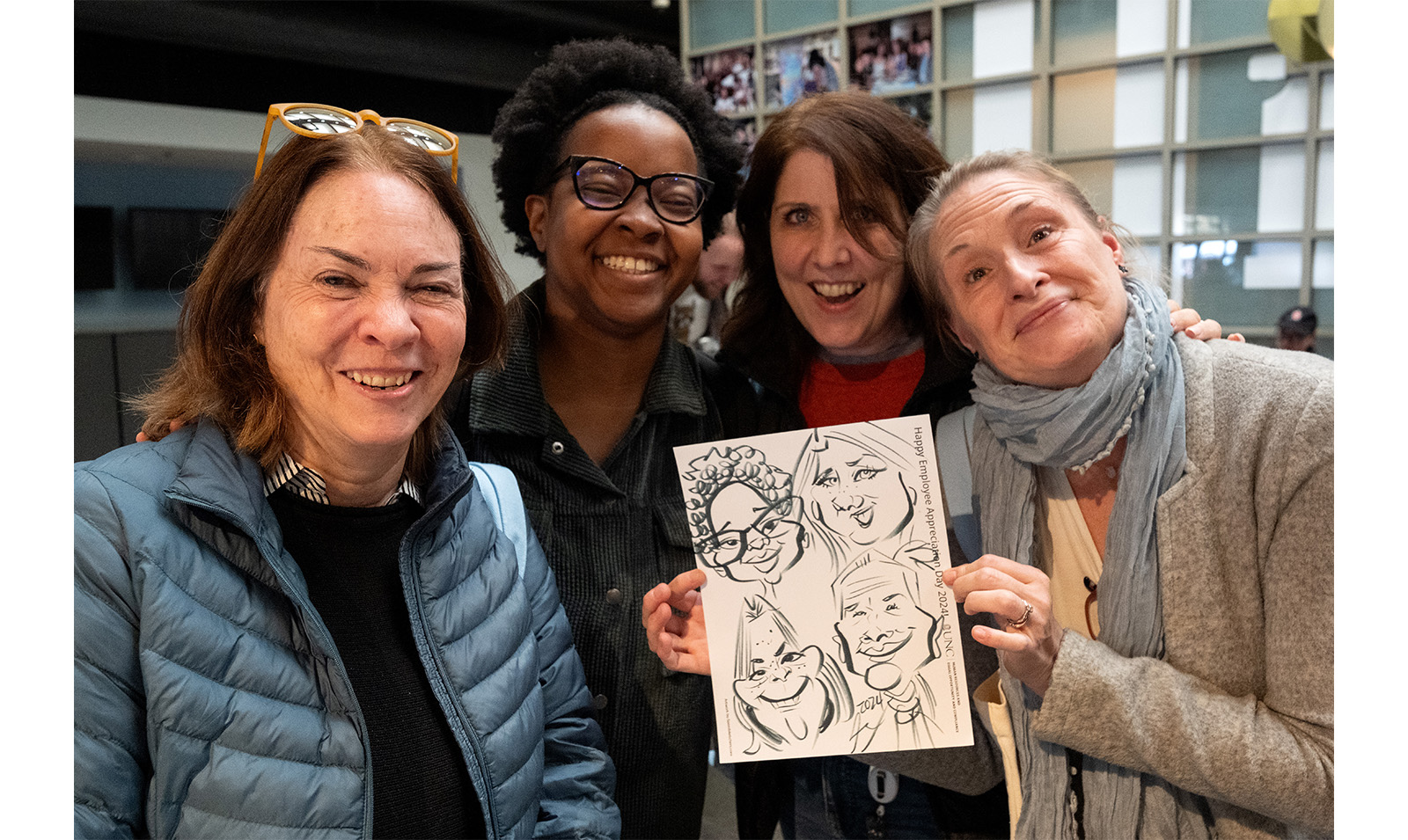 Carolina employees hold up custom caricature during Employee Appreciation Dau