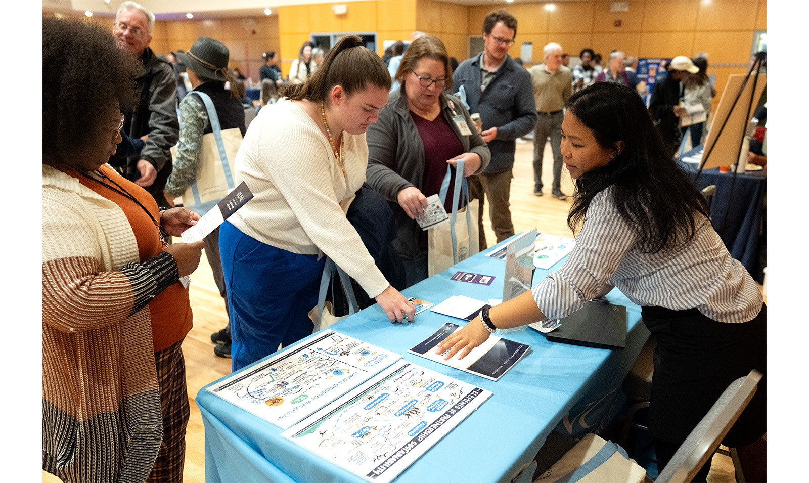 Carolina employees look at resources on a table