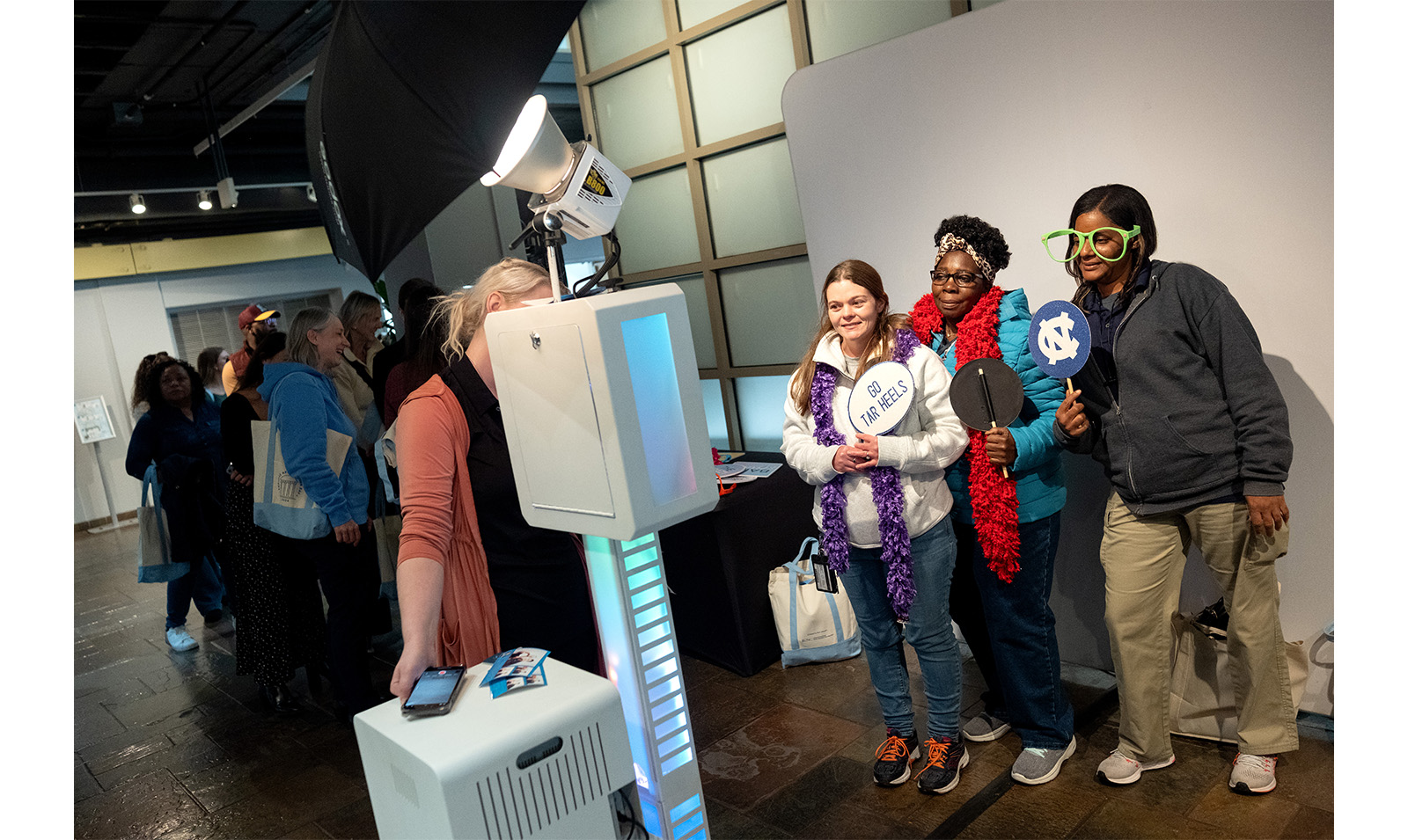 Carolina employees hold up signs at photo booth