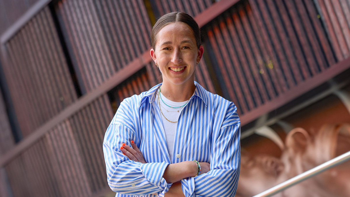 Darcy McFarlane posing in blue button up shirt.