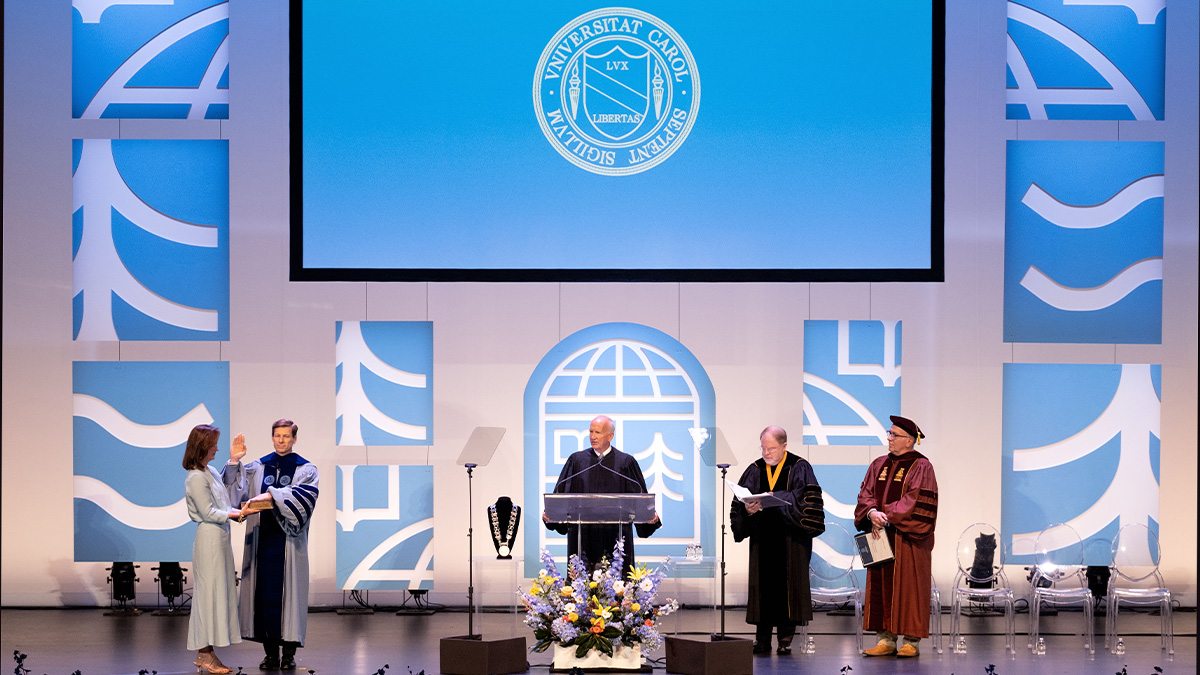 Wide-angle shot of the stage in Memorial Hall on the campus of UNC-Chapel Hill during the inauguration of Chancellor Lee H. Roberts on University Day. Roberts is seen taking his oath of office with his hand on the Bible.