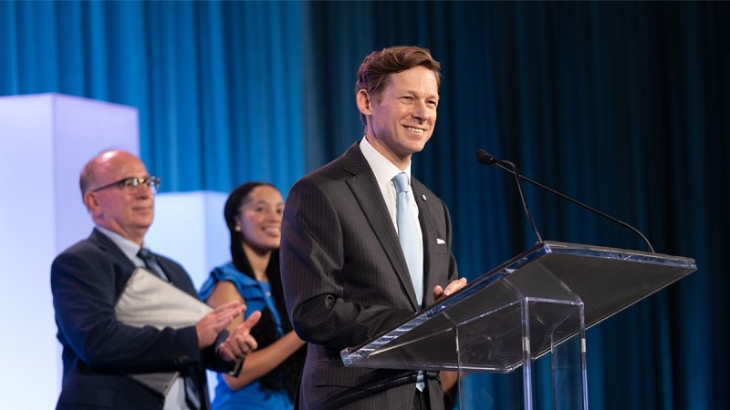 Lee H. Roberts standing at a podium.