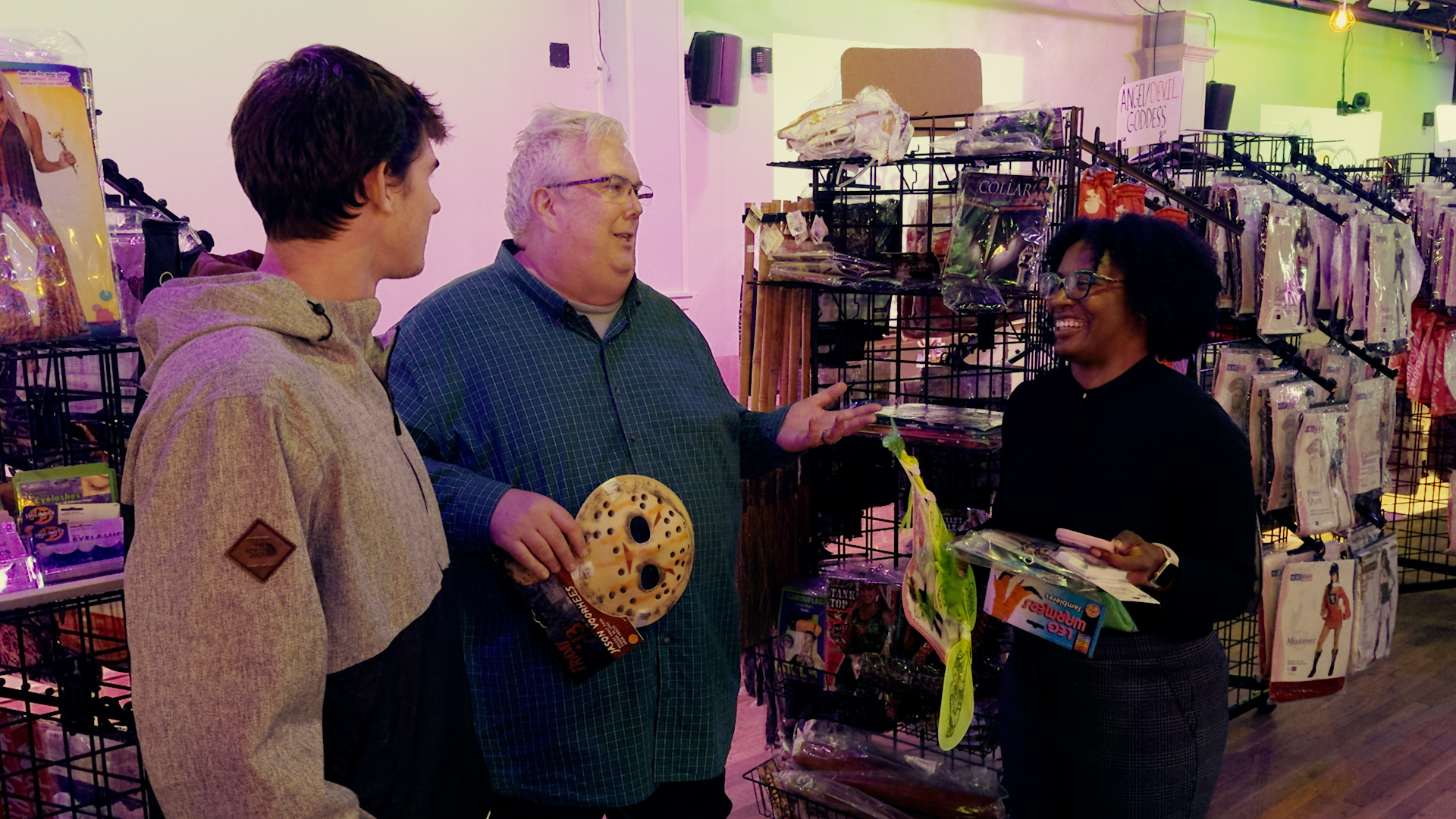 Professor Tim Flood talks with students inside the Heel-O-Ween pop-up store